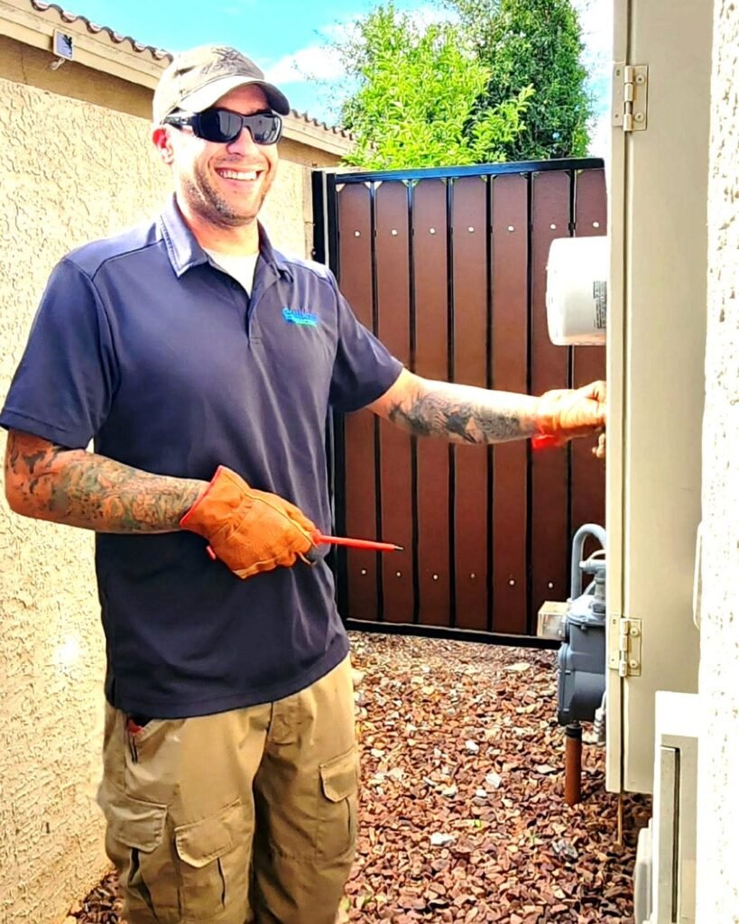 Smiling electrician working at an electric meter in Plattsburgh, NY