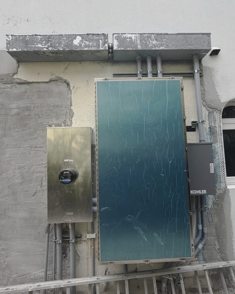 Kohler standby generator beside a meter and electrical panel in Plattsburgh, NY