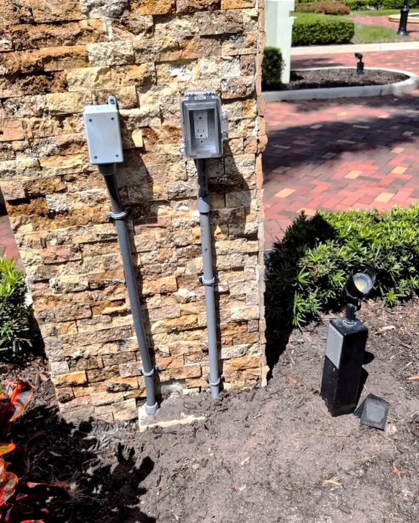 Stone column with outdoor outlets and a landscape light in Plattsburgh, NY