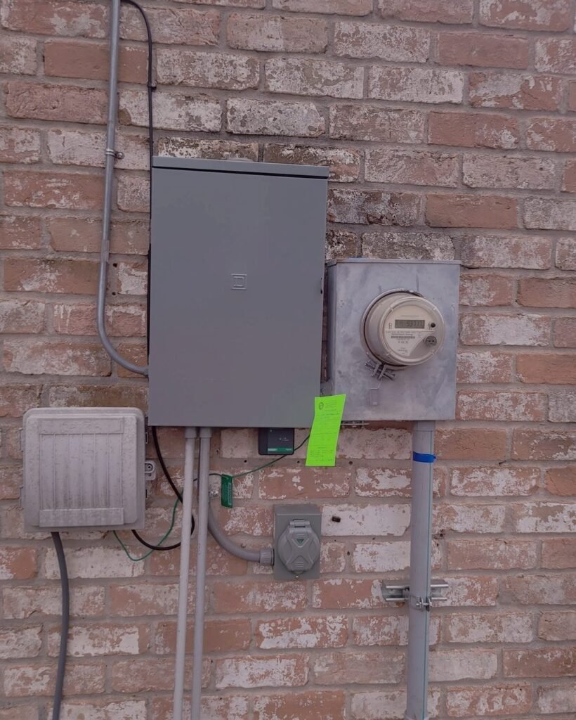 New electrical panel and meter mounted on a brick wall in Plattsburgh, NY
